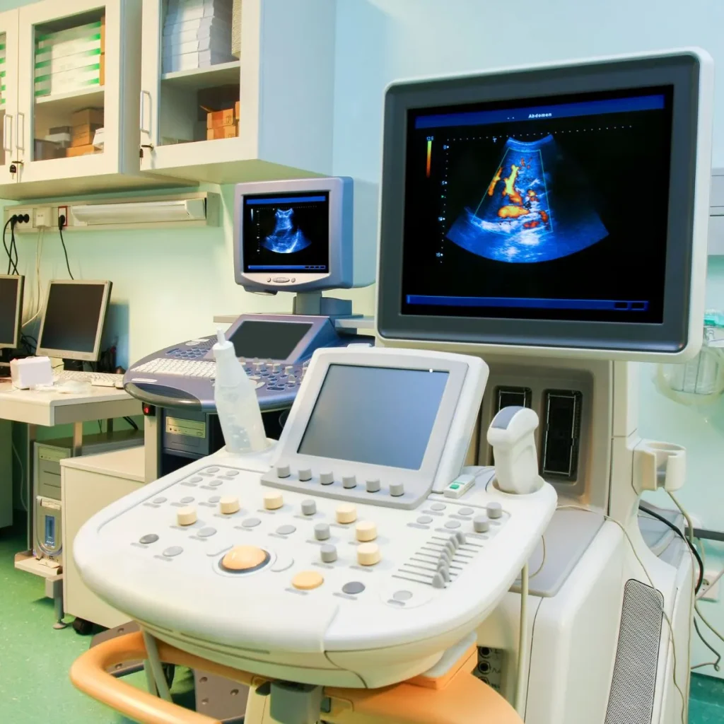 Estação de trabalho médica com aparelho de ultrassom doppler colorido exibindo fluxo sanguíneo para emissão de laudo vascular.